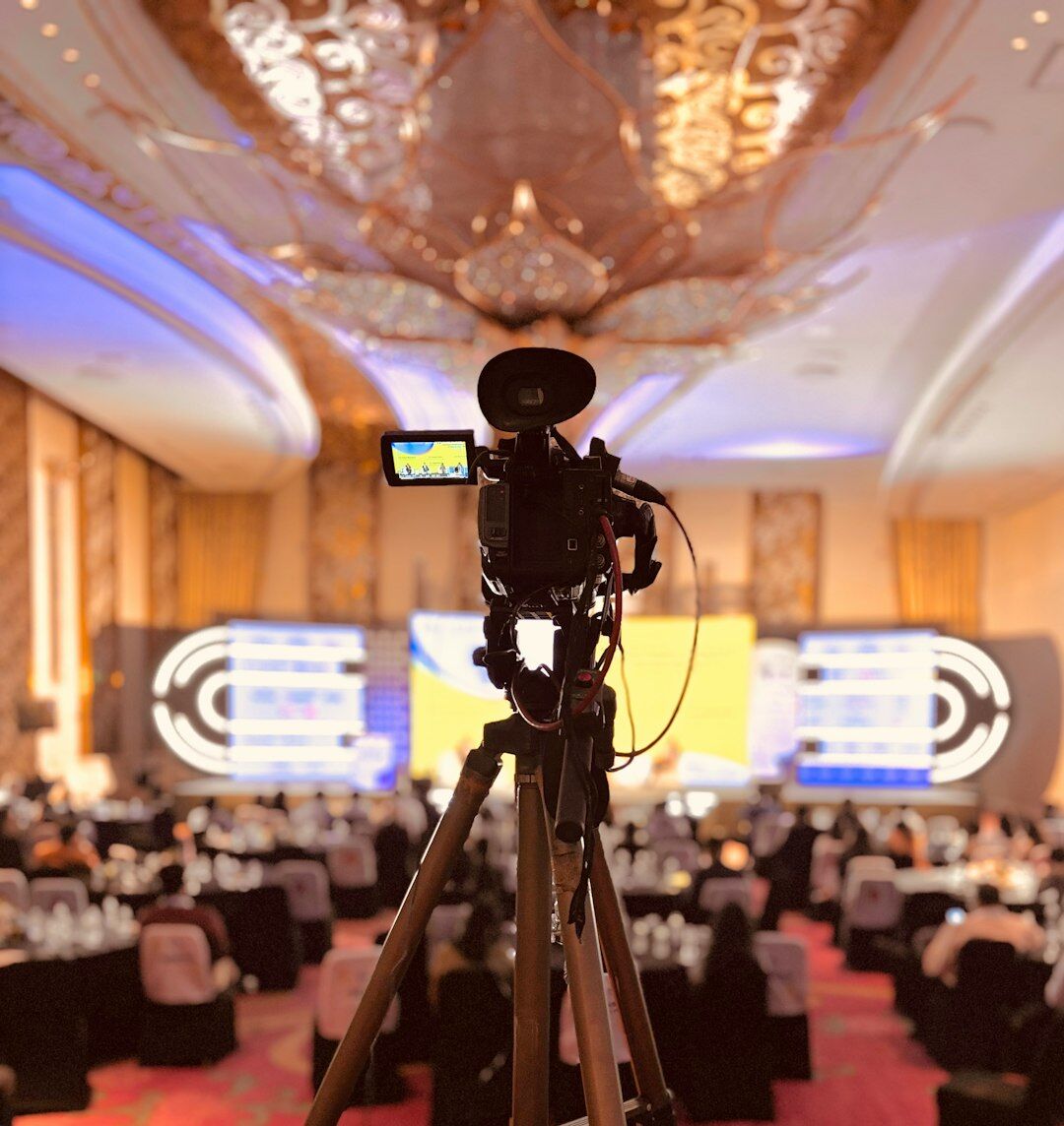 TV camera focusing on a reporter during a live broadcast